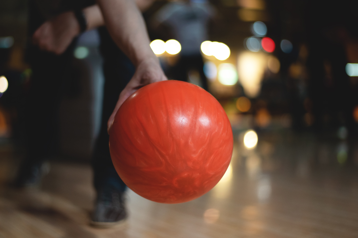 A figure is holding a bowling ball to throw
