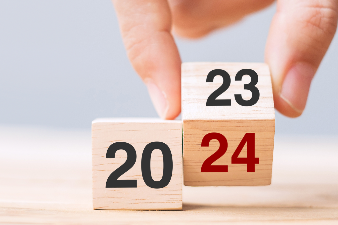 Year in review: Two fingers change wooden blocks from year 2023 to 2024