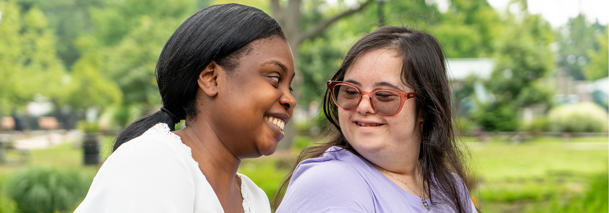 Two women smiling while enjoying the park