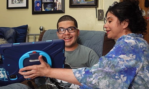woman holding tablet while looking at it with a member