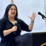 Regional Director Holli Rubiano speaks at the conference.